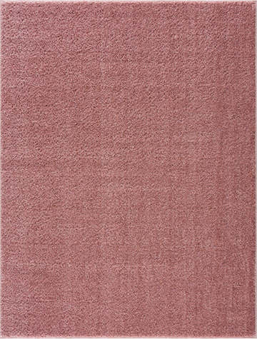 Close-up of the Judy Pink Plush Washable Area Rug showing its soft, textured shag and subtle pink color. Design-Rectangle