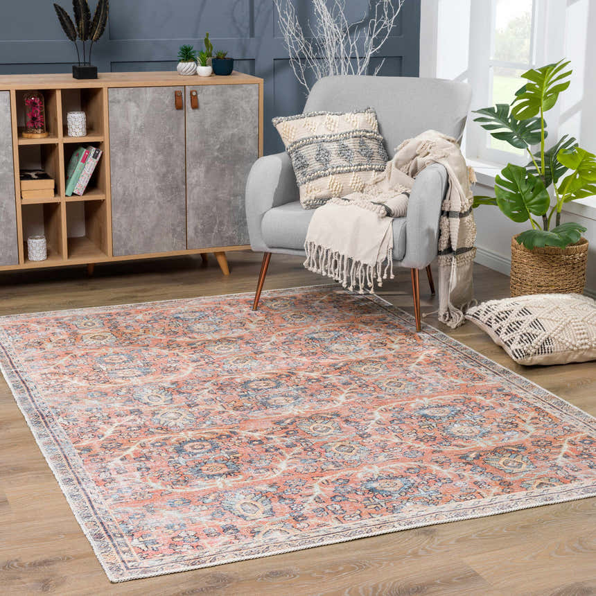 Living room scene with Urpi Rose & Blue Washable Area Rug, gray armchair, wood cabinet, and indoor plants. Roomscene-Rectangle