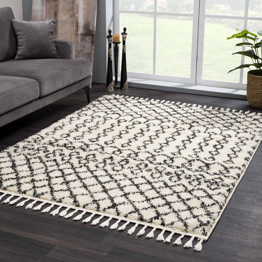 Living room scene with a gray sofa and Muni Berber Shag Rug in charcoal and light beige with tassels. Roomscene-Rectangle