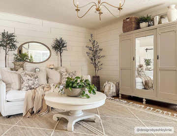 Living room with a Gulnur Natural Jute&Wool Trellis Rug, white sofa, round table, and farmhouse decor. Cream and tan tones. Roomscene-Rectangle