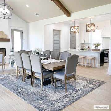 Open concept dining room with gray Newalla Area Rug under a wood table and gray chairs. Roomscene-Rectangle