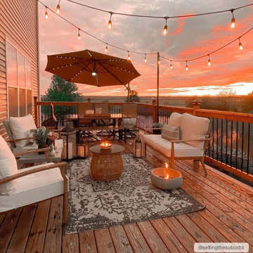 Outdoor patio scene with Charcoal Kilmacolm rug, white seating, lanterns, and sunset view. Roomscene-Rectangle