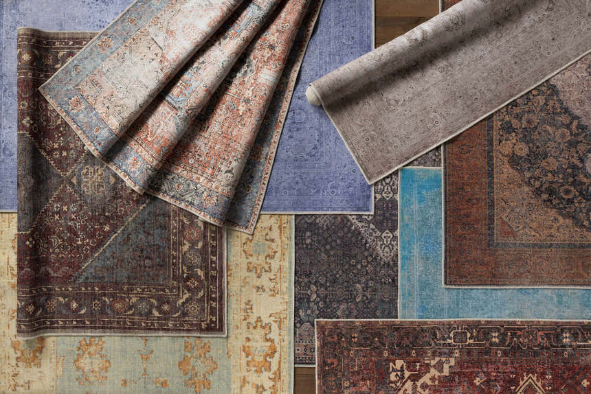 Close-up of multiple Maplesville Washable Area Rugs in beige, pink, plum, green, rust, and teal with traditional patterns. Styleshot