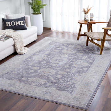 Living room scene with a Karuah Thick Luxe Statement Rug in gray and beige, white sofa, and wood accents. Roomscene-Rectangle