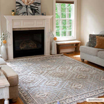 Living room scene with a cream sofa and the Agoo High-Low Pile Rustic Rug in charcoal, cream, and light beige. Roomscene-Rectangle