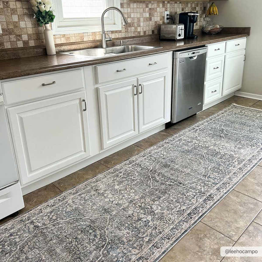 Gray Anouk runner rug in a bright kitchen with white cabinets and brown tile floor. Roomscene-Runner