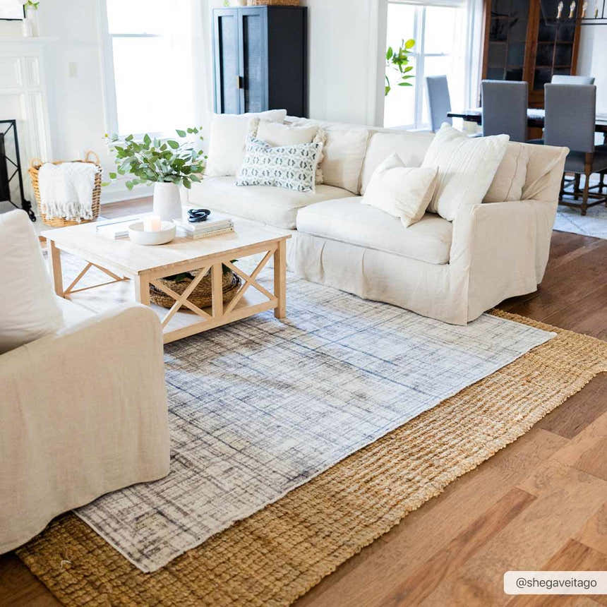 Living room scene with layered rugs: jute rug under the Taysan Area Rug. Neutral tones, bright, airy. Roomscene-Rectangle