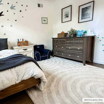 Kids bedroom with white walls, wood furniture, and a soft, cream Arnel Area Rug. Roomscene-Rectangle