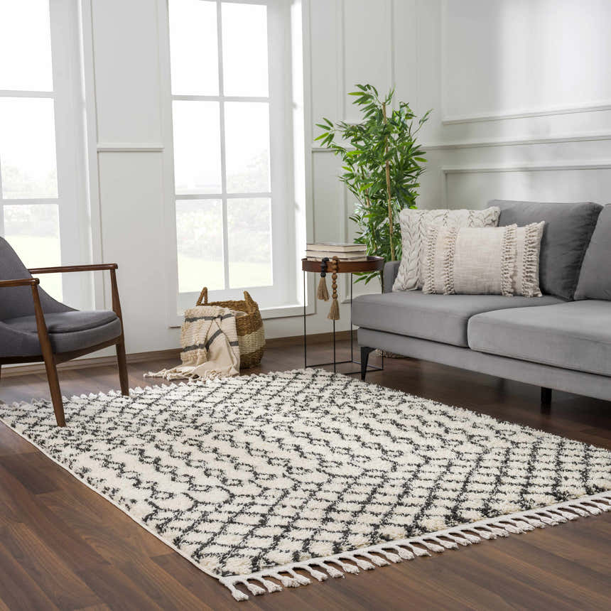 Living room scene with a Muni Berber Shag Rug in charcoal and light beige, gray sofa, and wood floors. Roomscene-Rectangle