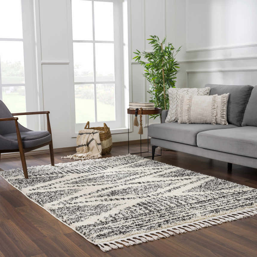 Living room scene with a gray sofa and Fishhook Berber Shag Rug in dark gray and lambswool. Modern, Scandinavian style. Roomscene-Rectangle