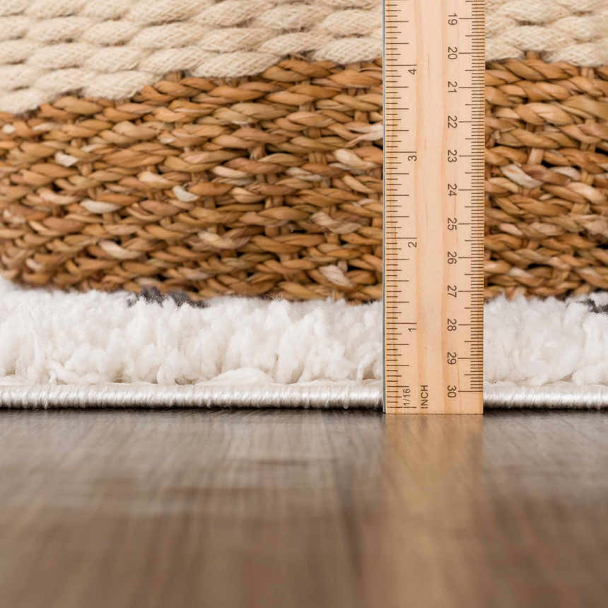 Close-up of the plush texture and pile height of the Chaia Dotted Black & White shag rug. Ruler for scale. Pile