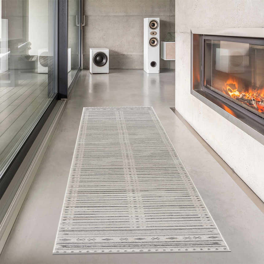 Modern living room with fireplace and Tigri Aztec Ivory & Gray area rug runner on concrete floor. Roomscene-Runner