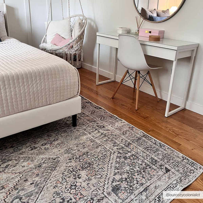 Bedroom scene with Barny Tan Washable Area Rug. Features a bed, desk, hanging chair, and traditional rug with black, gray, and peach tones. Roomscene-Rectangle