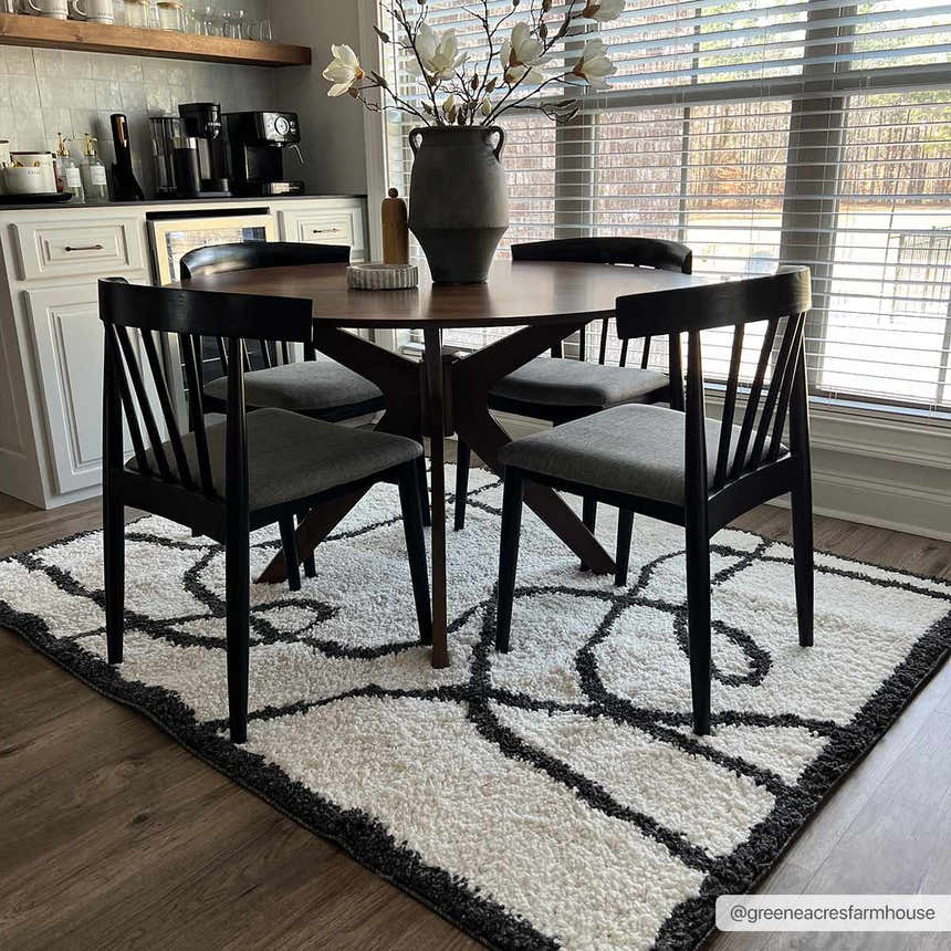 Dining room with a round table and the Brad Area Rug in black and white. Modern shag rug. Roomscene-Rectangle