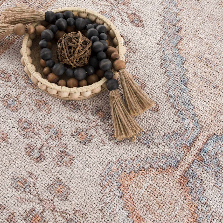 Close-up of the Analu Non-Slip Washable Rug, showcasing its brown, tan, and light blue vintage-style pattern and soft texture. Styleshot