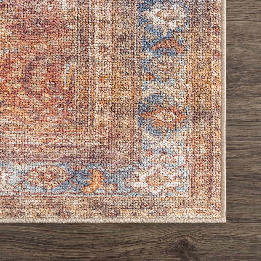 Close-up of the Anshu Peach Washable Area Rug, showing its traditional vintage design, beige, blue, and burgundy colors and textured weave. Swatch