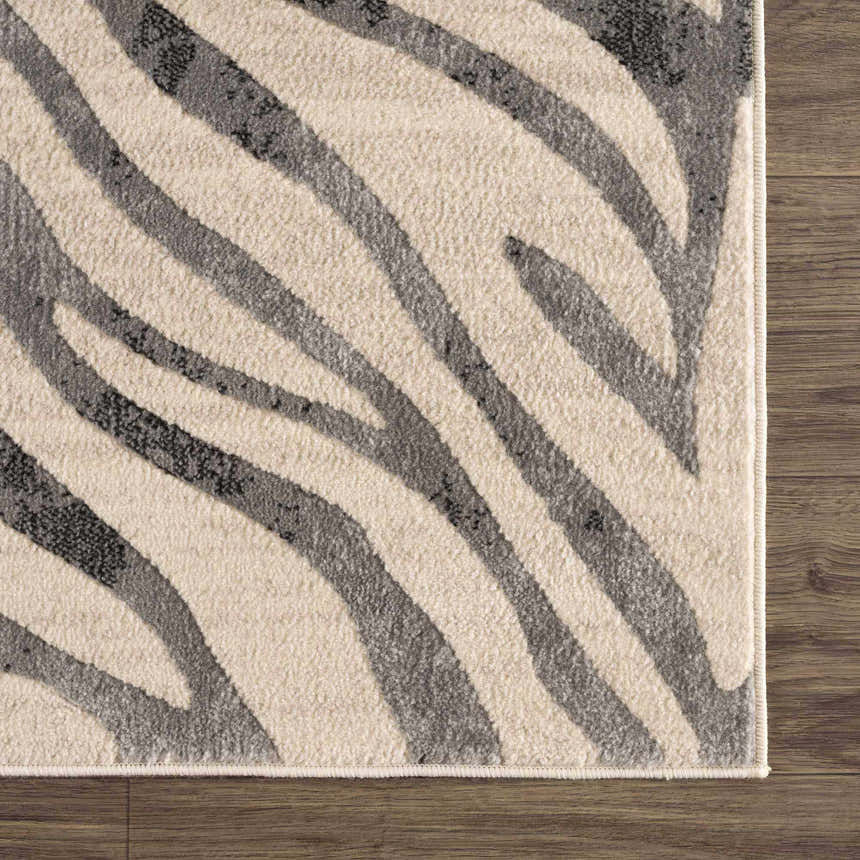 Close-up of the Gray Ecorse Zebra Print Area Rug showing the charcoal and light beige animal stripes and machine-woven texture. Swatch