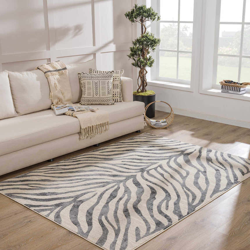 Living room with a neutral sofa and Gray Ecorse Zebra Print Area Rug on wood floor. Roomscene-Rectangle