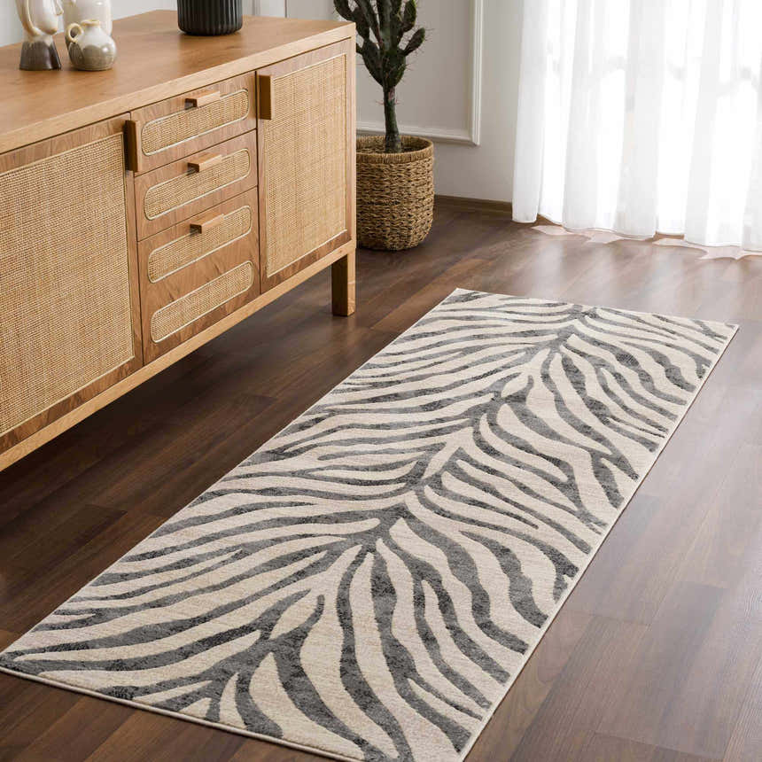 Living room scene with a Gray Ecorse Zebra Print Area Rug, wood floors, and a light wood mid-century modern cabinet. Roomscene-Runner
