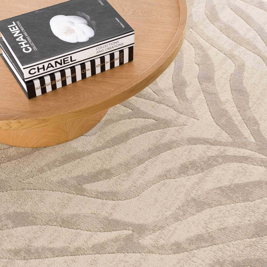 Close-up of the Beige Manteca Zebra Print Area Rug showing its light beige and gray wavy pattern. Styleshot