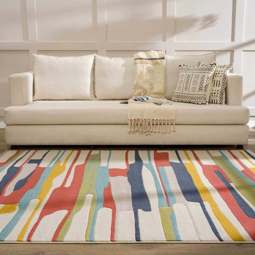 Living room scene with a Southfields Colorful Modern Area Carpet and a beige sofa with decorative pillows. Roomscene-Rectangle