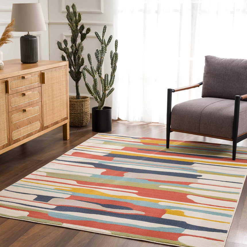 Living room scene with a Southfields Colorful Modern Area Carpet, wood cabinet, gray chair, and cactus plants. Roomscene-Rectangle