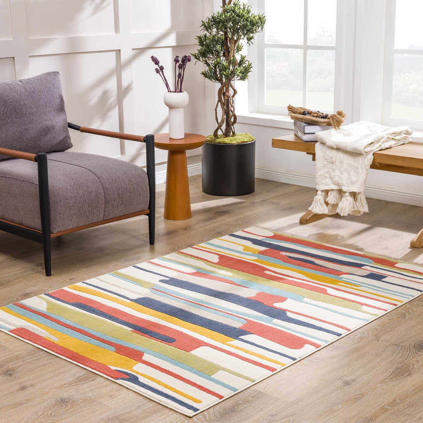 Light-filled living room with a gray chair and the Southfields Colorful Modern Area Carpet with stripes of blue, red, and yellow. Roomscene-Rectangle