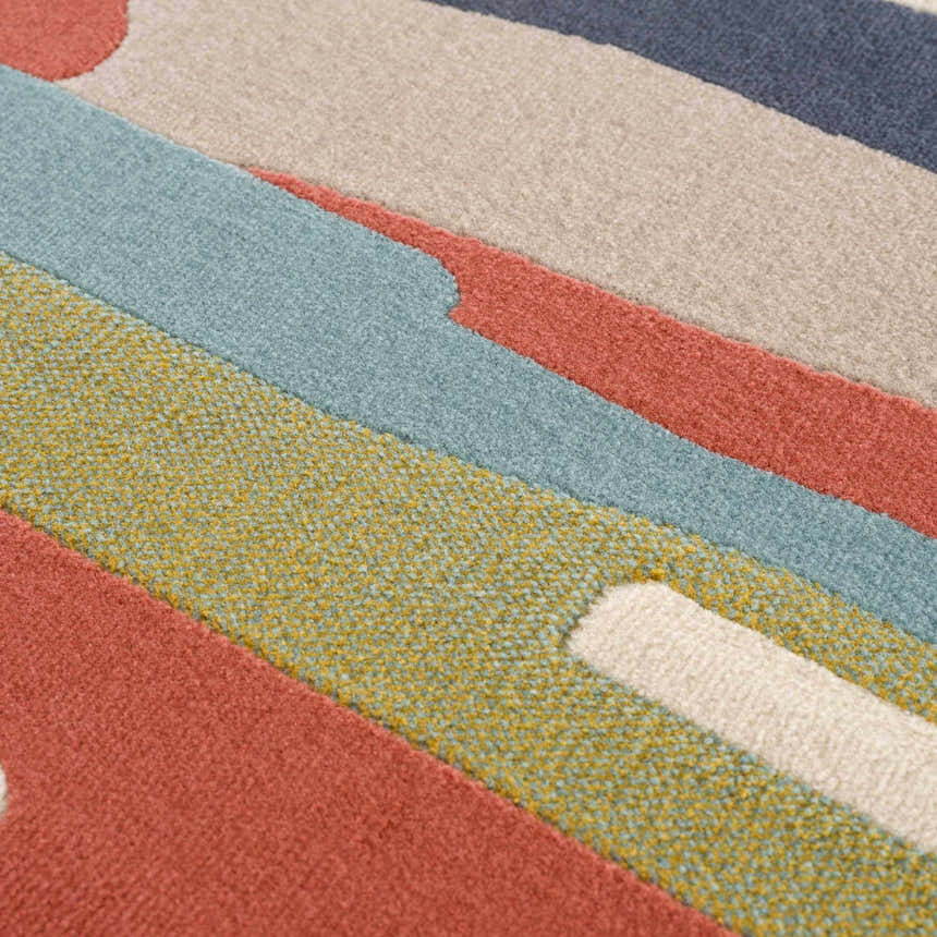 Close-up of Southfields Colorful Modern Area Carpet showing texture and colors: aqua, charcoal, peach, mustard, and beige. Texture