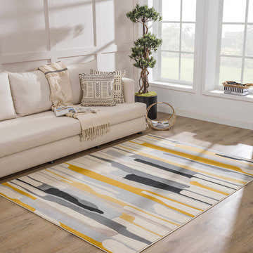 Living room with a cream sofa and the Southfields Mustard Modern Rug with black, gray, and yellow stripes. Roomscene-Rectangle