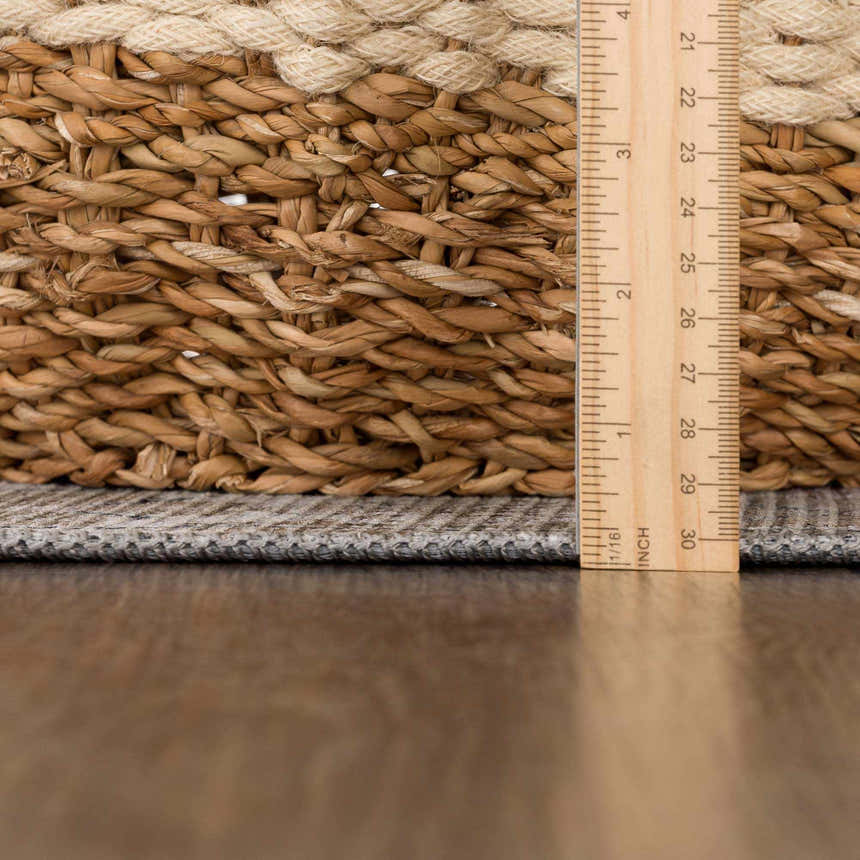 Close-up of the Baltinglass Flat Pile Washable Rug showing its flat weave and chenille-polyester texture next to a ruler. Pile
