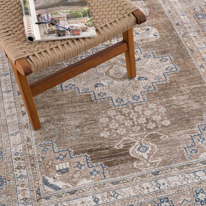 Close-up of the Baltinglass Flat Pile Washable Rug. Features a traditional oriental pattern in blue, cream, and beige tones. Styleshot