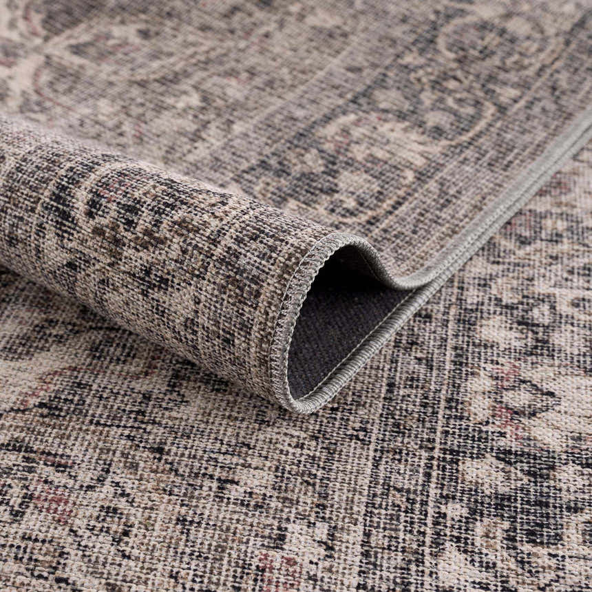 Close-up of the Greenpoint Dusty Blue Washable Rug showing its chenille texture and vintage-inspired oriental pattern. Fold