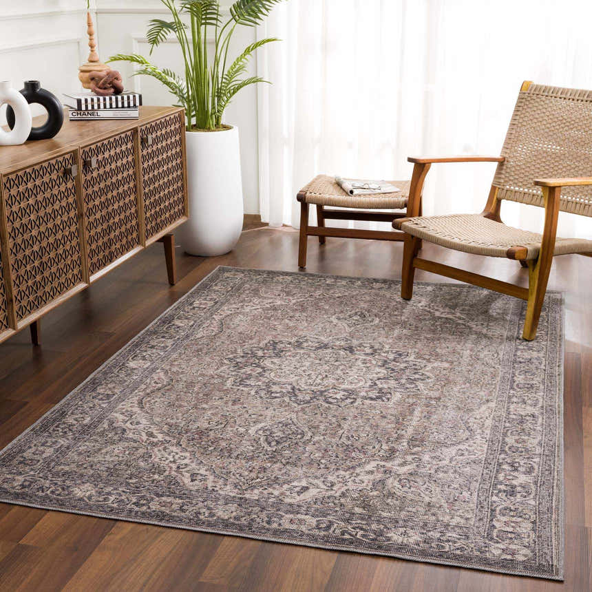 Living room scene with a Greenpoint Dusty Blue Washable Rug, wood cabinet, woven chairs, and a potted plant. Roomscene-Rectangle