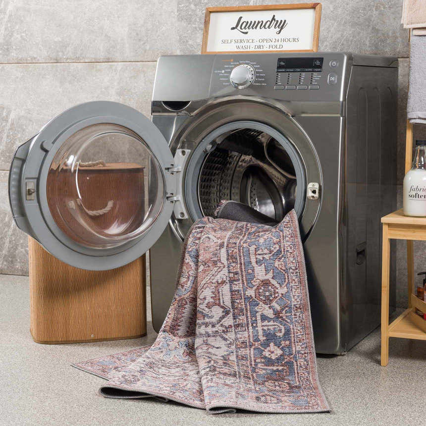 Viho Vintage Flat Pile Washable Rug being washed in a laundry room with gray tile and a front load washing machine. Washing-Machine