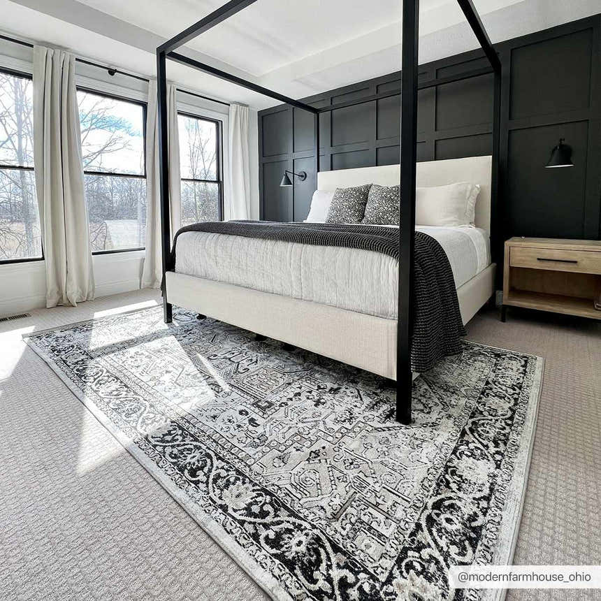 Bedroom scene with black canopy bed and the black and gray vintage Cabacungan Washable Area Rug. Roomscene-Rectangle
