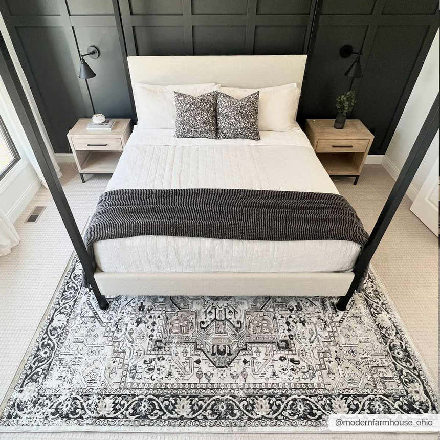 Bedroom scene with a black and gray Cabacungan Washable Area Rug under a four-poster bed. Modern farmhouse style. Roomscene-Rectangle
