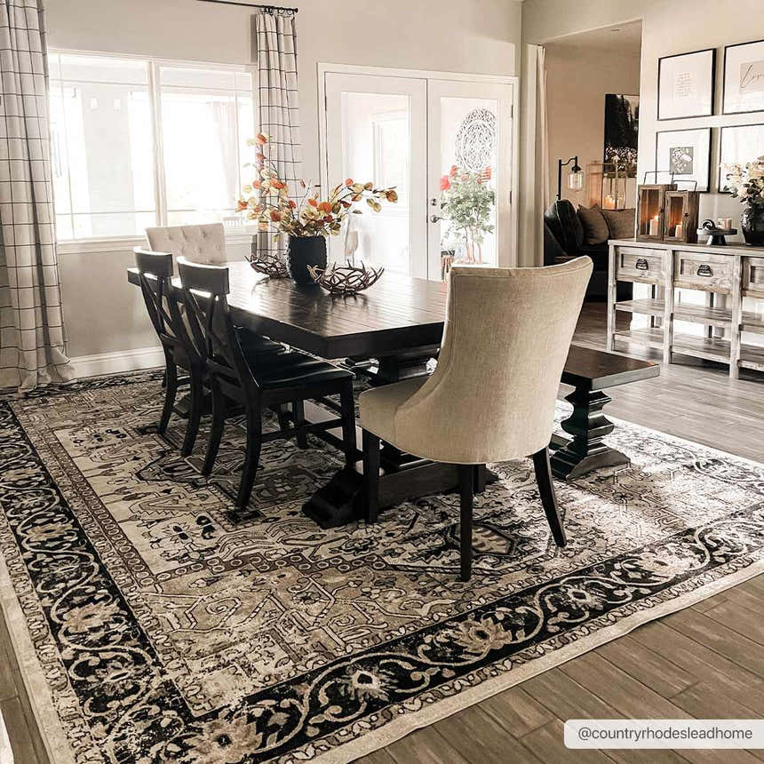 Dining room with a dark wood table on a Cabacungan Washable Area Rug in black, gray, and beige. Farmhouse style. Roomscene-Rectangle