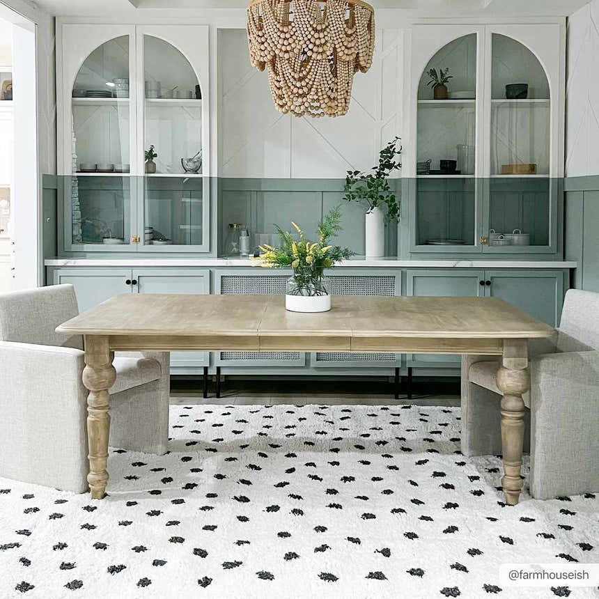 Dining room with a Chaia Dotted Black & White Plush Rug, light wood table, and sage green cabinets. Modern farmhouse style. Roomscene-Rectangle