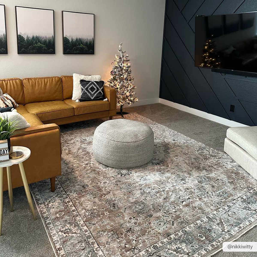 Living room scene with a brick red and light gray Civankan Area Rug, leather couch, and herringbone accent wall. Roomscene-Rectangle