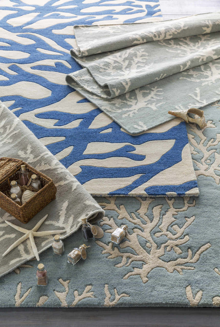 Close-up of the Merchantville Area Rug in ivory, light gray, and blue with a contemporary coral design. 100% Wool. Styleshot