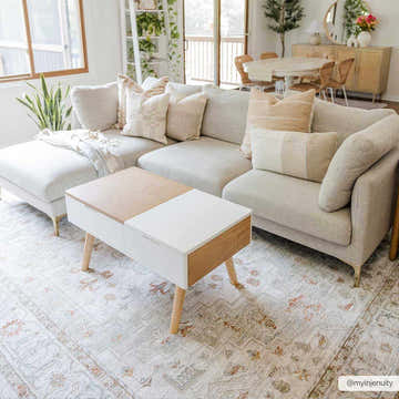 Living room scene with a beige sectional sofa and Dieppe Thick Luxe Statement Rug in beige and rust tones. Roomscene-Rectangle