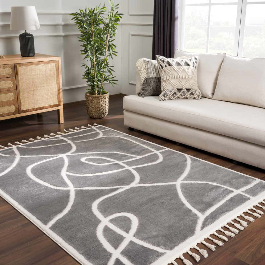 Living room scene with Azana Modern Gray Area Rug, cream sofa, wood cabinet, and potted plant. Roomscene-Rectangle