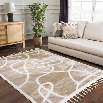 Living room scene with a cream sofa and the Azana Cream Area Rug with an abstract design and tassels. Roomscene-Rectangle
