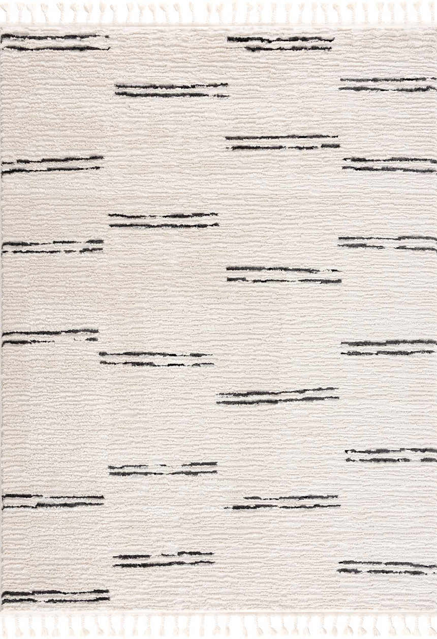 Close-up of the Riad Black Striped White Rug with Tassels. The rug features a textured bone color and black geometric stripes. Design-Rectangle-46
