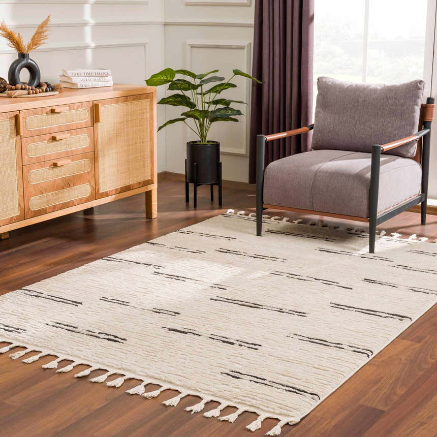 Living room scene with a Riad Black Striped White Rug, wood floors, accent chair, and wood cabinet. Roomscene-Rectangle