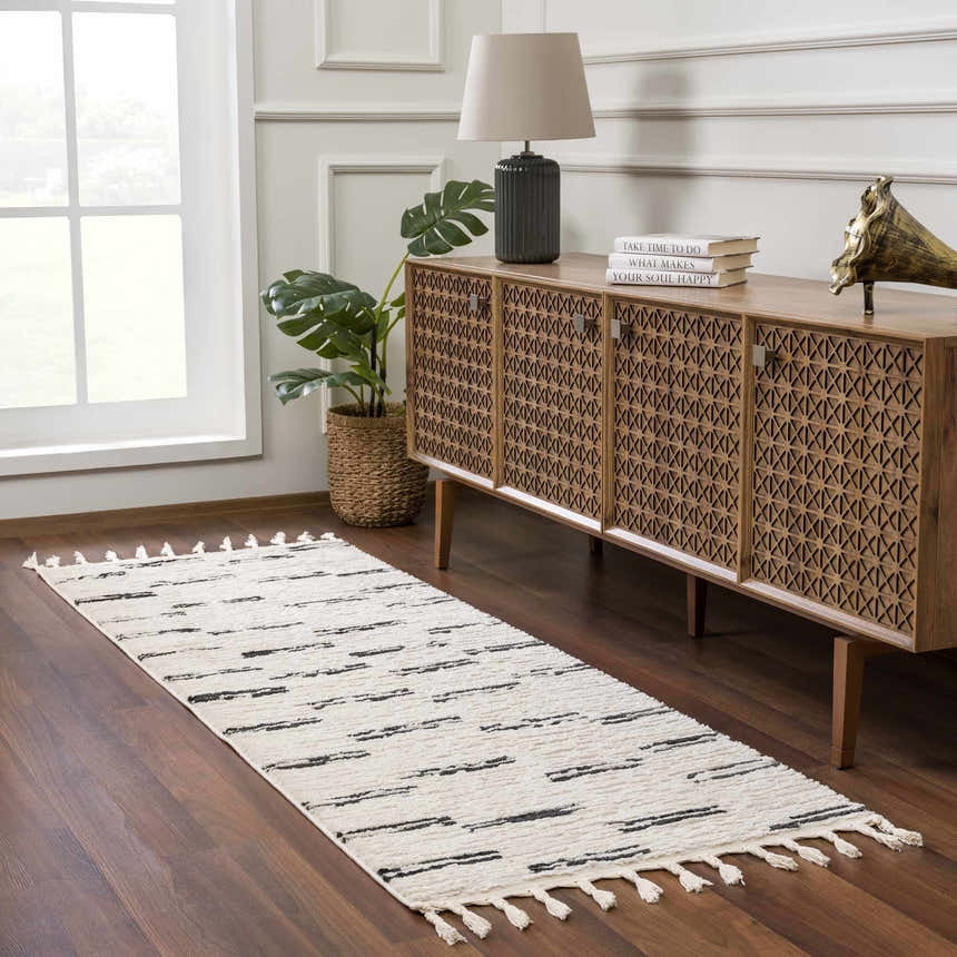 Entryway with wood console table and Riad Black Striped White Rug. Tasseled runner rug on dark wood floor. Roomscene-Runner
