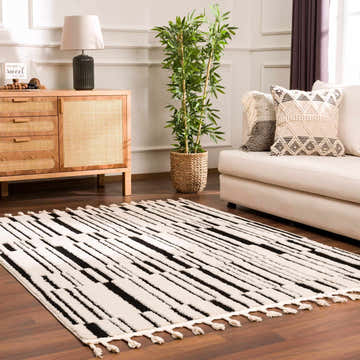 Living room scene with a beige sofa and the geometric Bansi Area Rug in beige and black. Roomscene-Rectangle