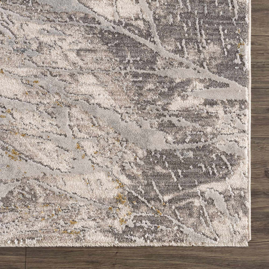 Close-up of the Hinda Textured Rug. Abstract pattern in dark brown, gray, and light gray on a textured polyester rug. Swatch
