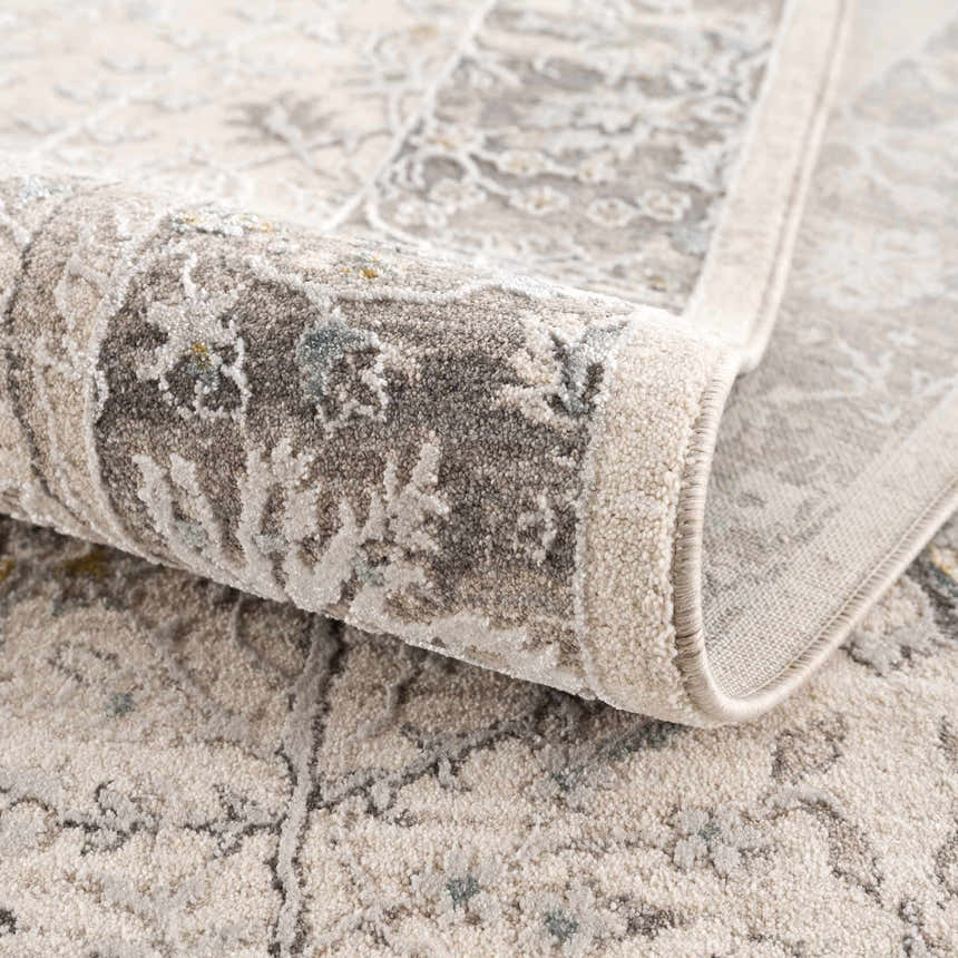 Close-up of the Gauge Cream & Gray Blue Rug showing its traditional pattern and soft, textured weave. Fold