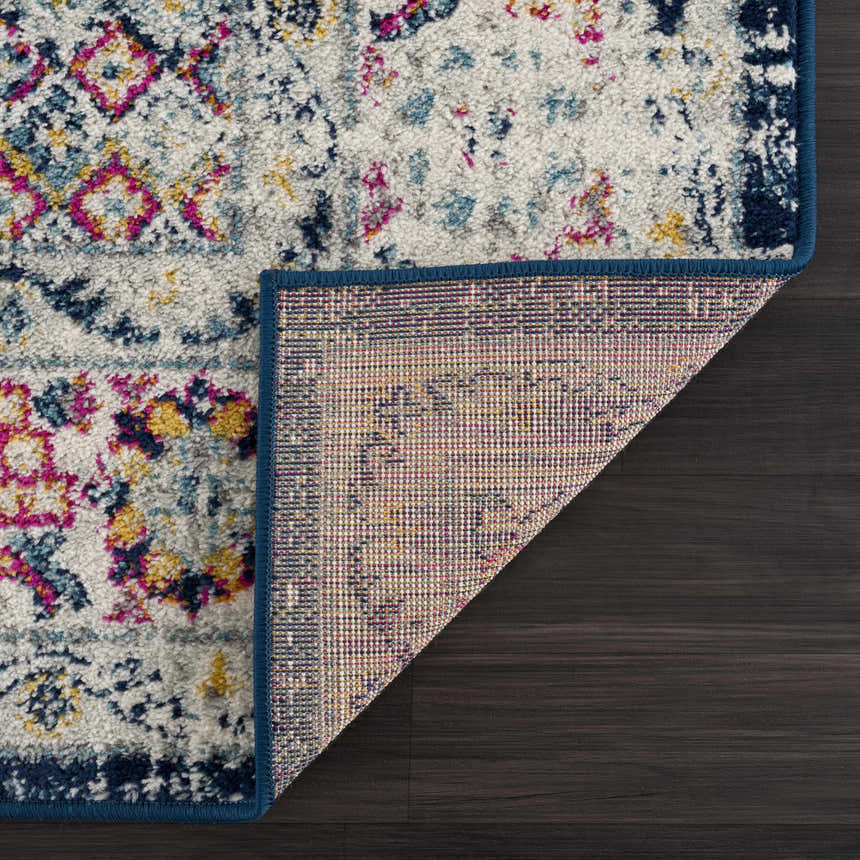 Close-up of the Marash KMRSH-4603 clearance runner rug. Features navy, orange, pink, and white in a traditional pattern. Fold